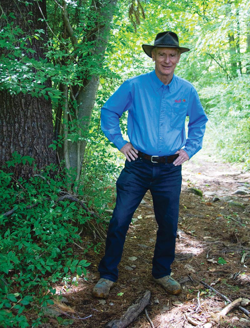 Bill Hull, founder of Hull Forest Products, Inc. standing among the trees