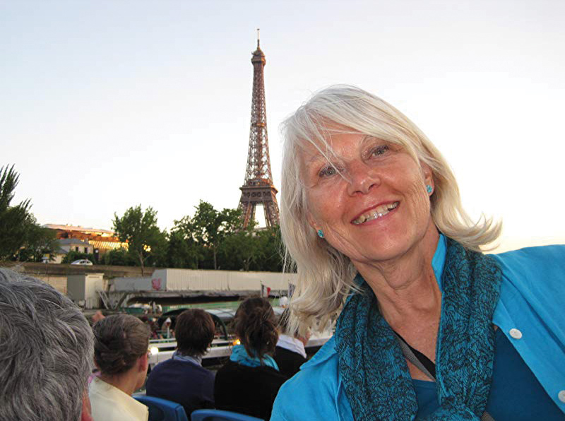 Gail Thorell Schilling standing by the Eiffel Tower