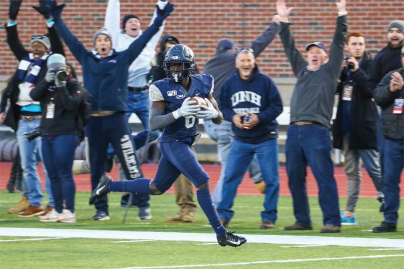 UNH football team celebrating a victory