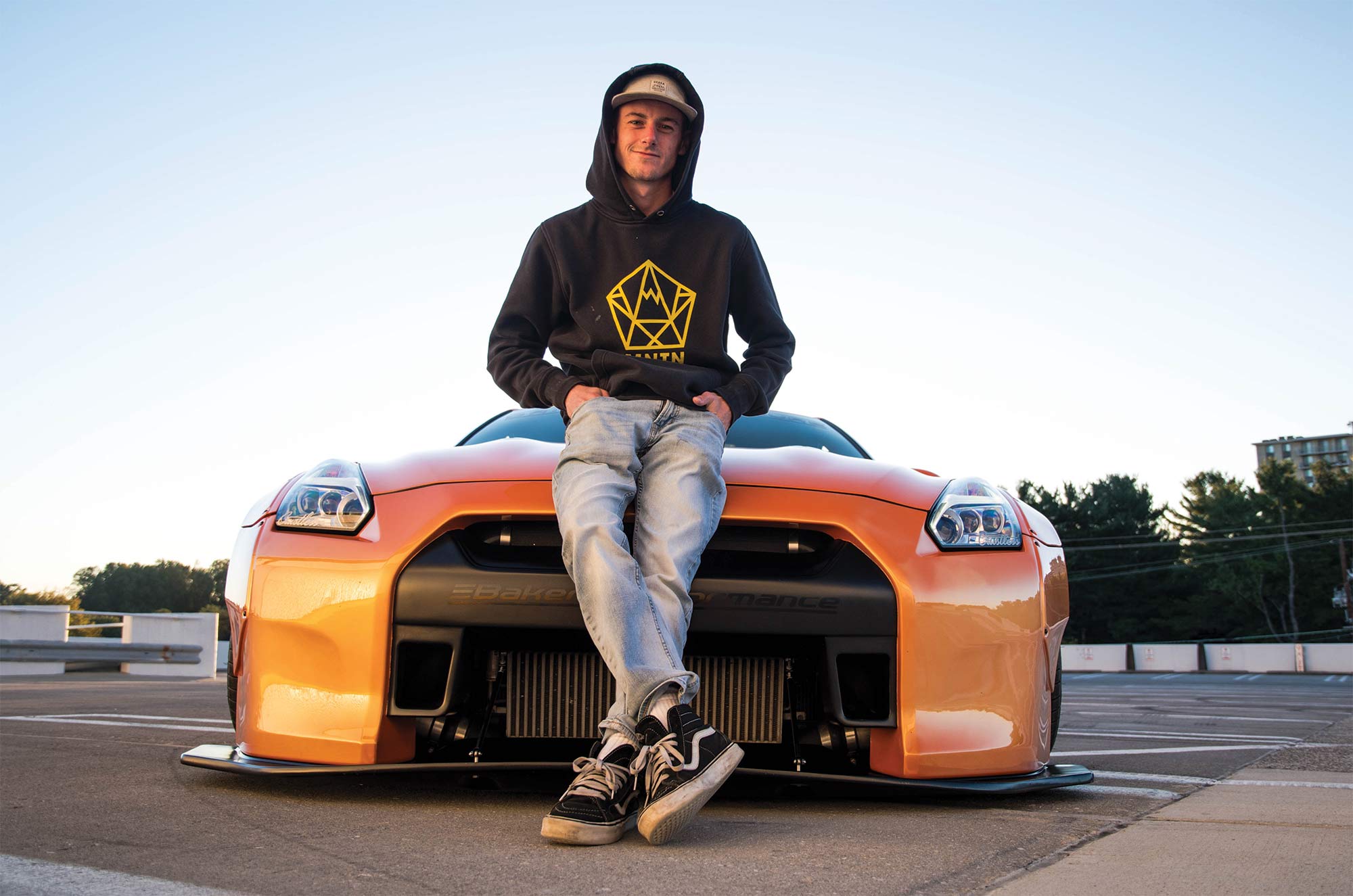 Andrew Lee on the hood of his Nissan GT-R - courtesy photo
