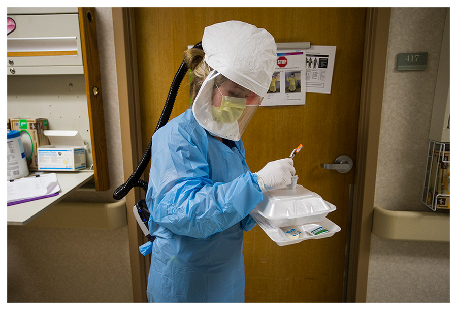 Registered nurse Jenny Koritz dons personal protective equipment