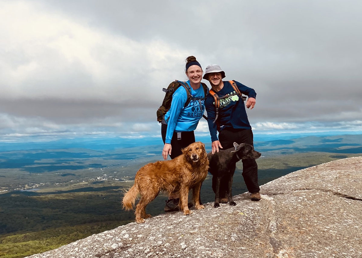 couple with dog on hike