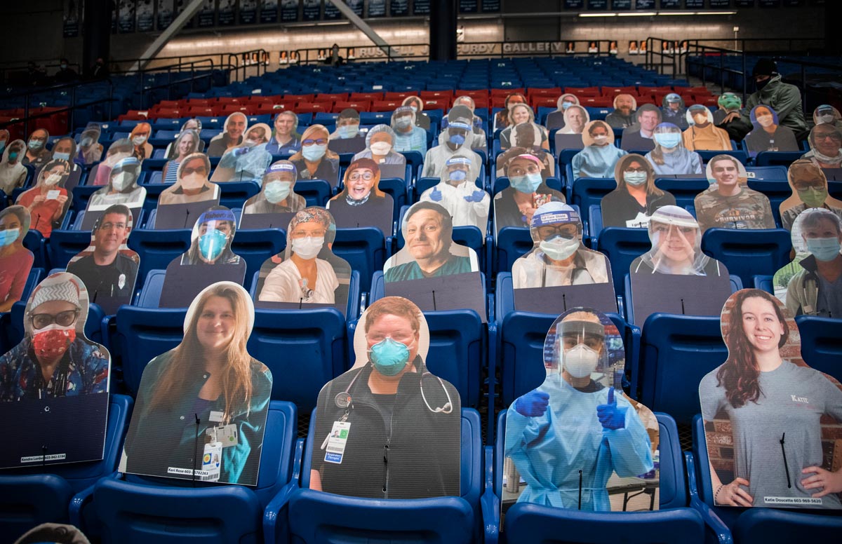 cardboard cutouts of healthcare workers in the stands at a sporting event