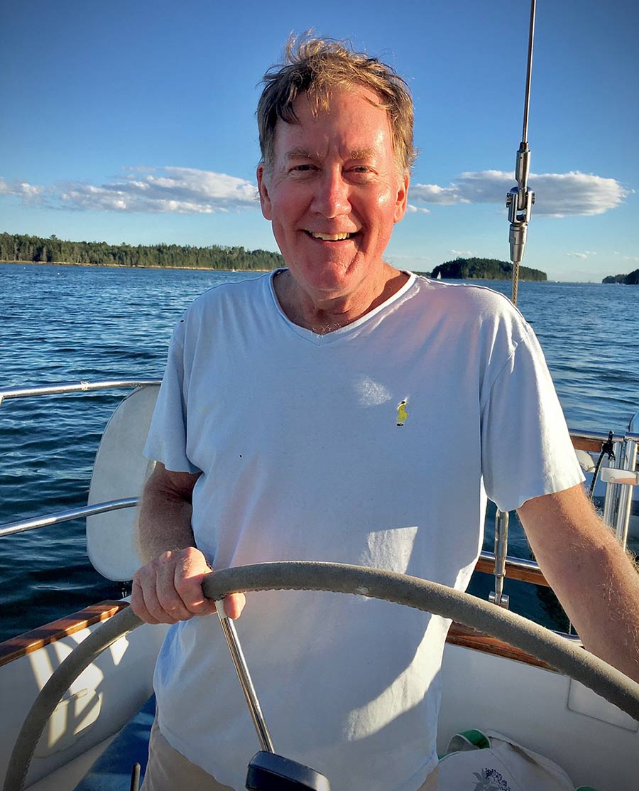 Peter Wright smiling on his sail boat
