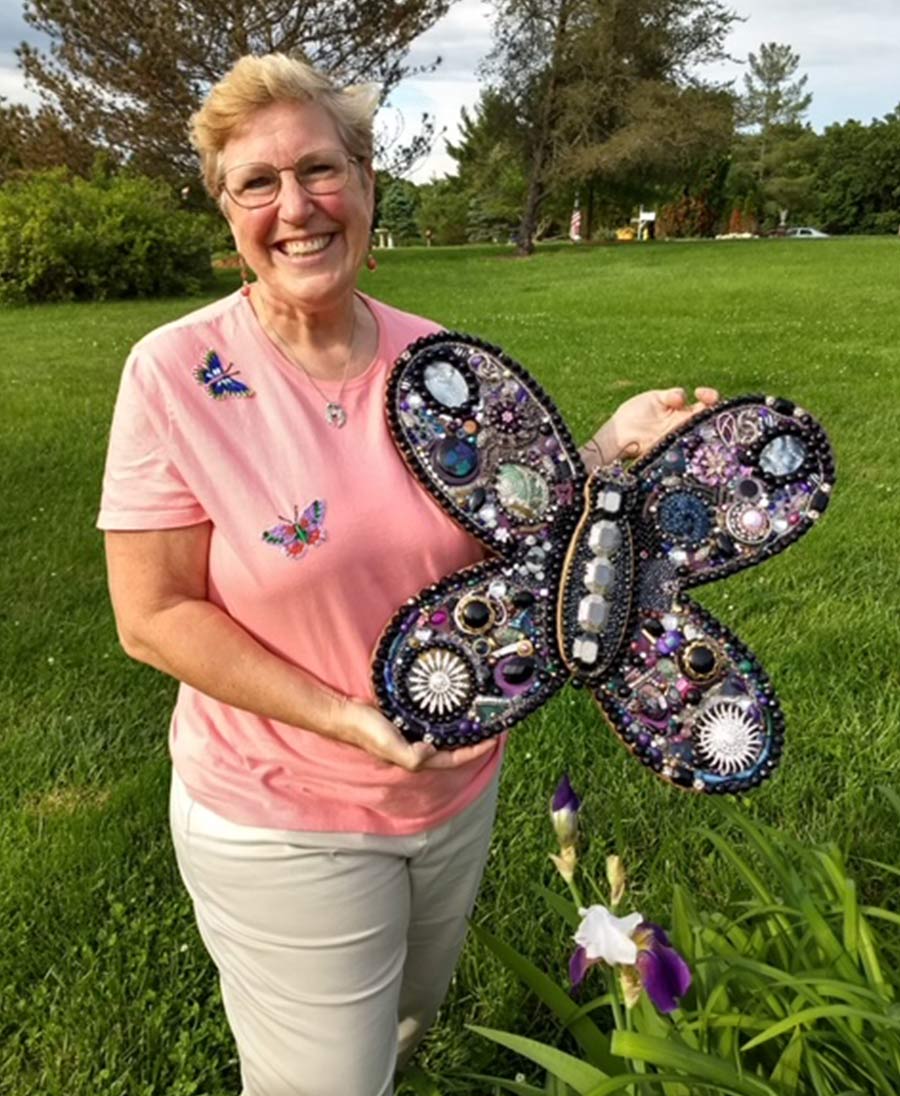 Brenda Fraser showing off one of her butterfly art pieces