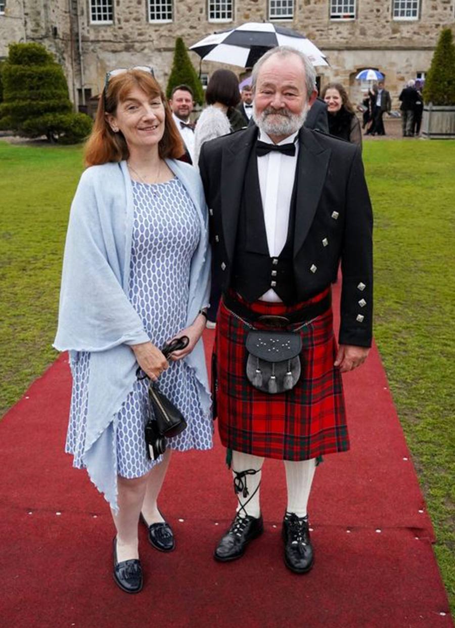 Deb Collings with her husband who is wearing the traditional Scottish dress