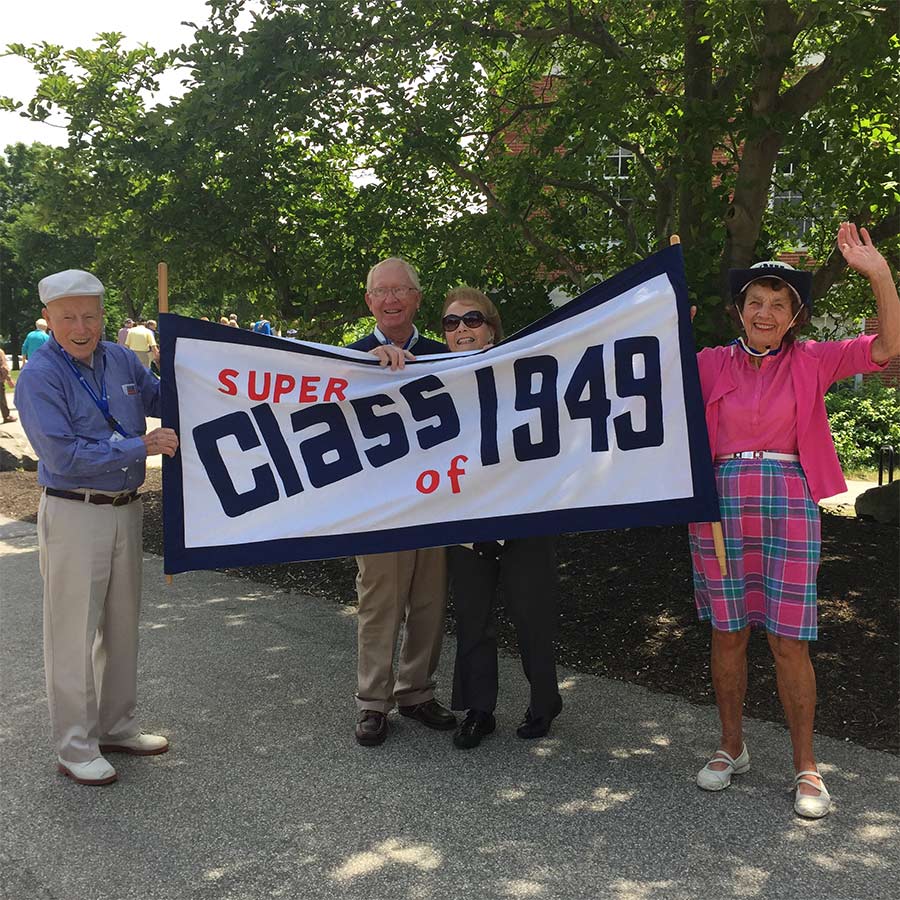 Stuart Eynon ’49, pictured here holding the class banner with 1949 secretary Joan Boodey Lamson at a past reunion