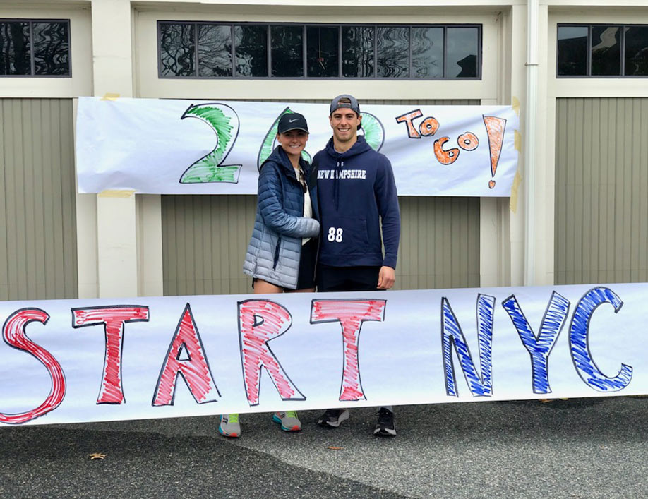 Gabriela Bochenczyk and Max Craig standing with their "Start NYC" banner