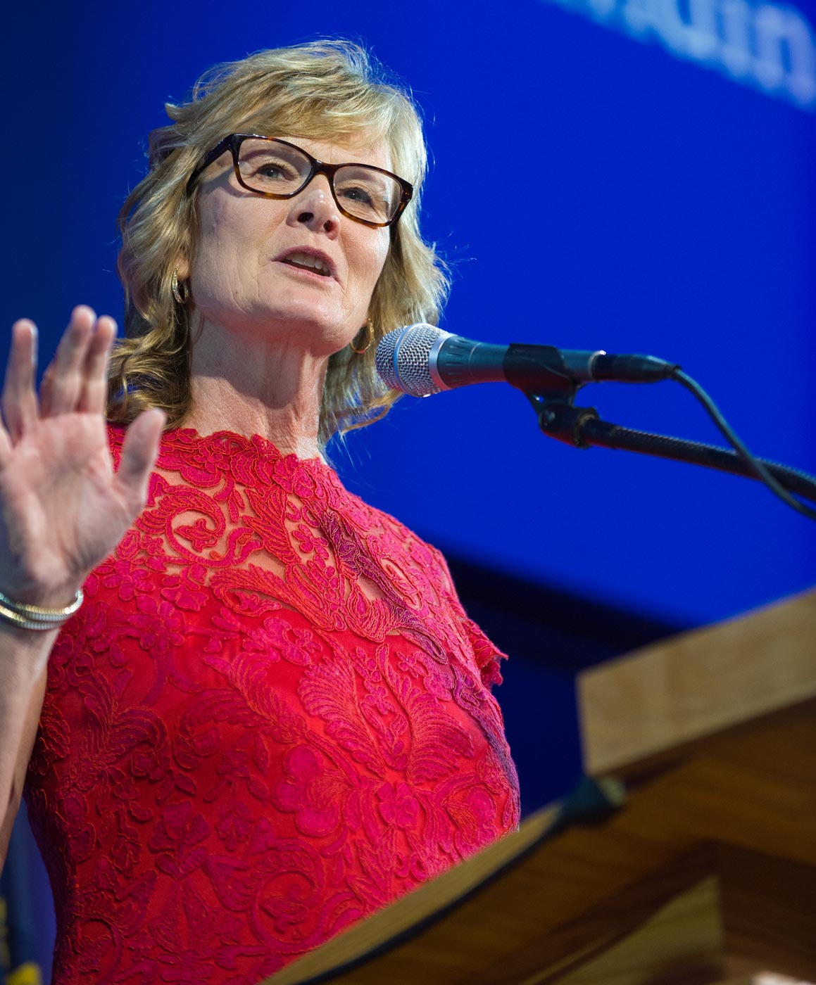 close view of Jackie MacMullan on a stage speaking into a microphone