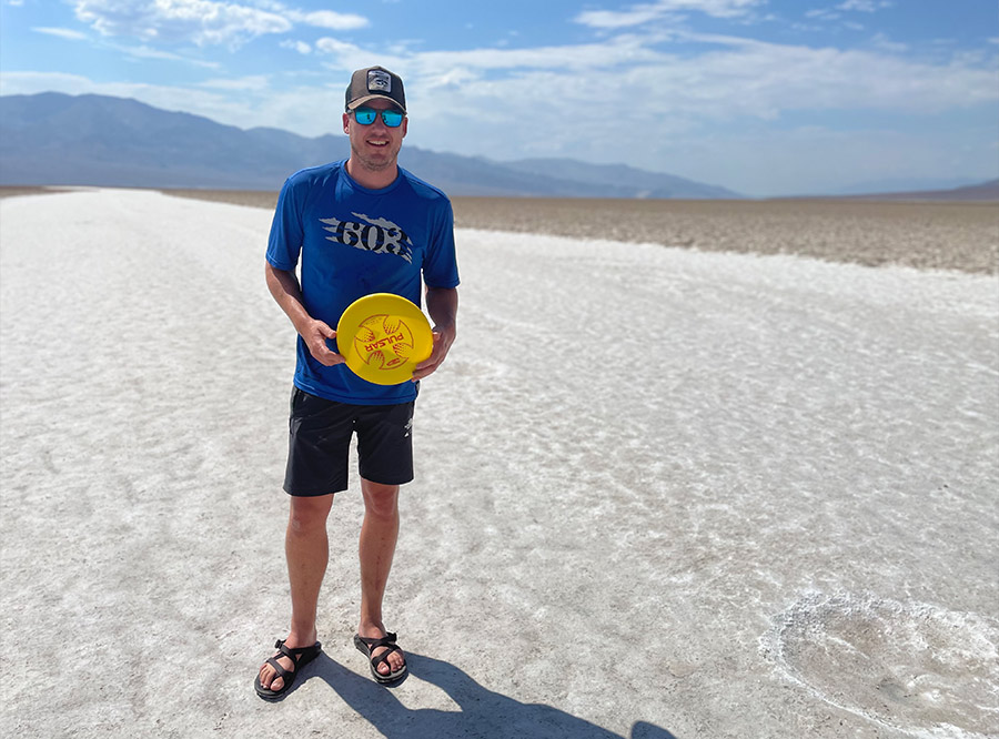 Evan Welsh holding a frisbee in Death Valley