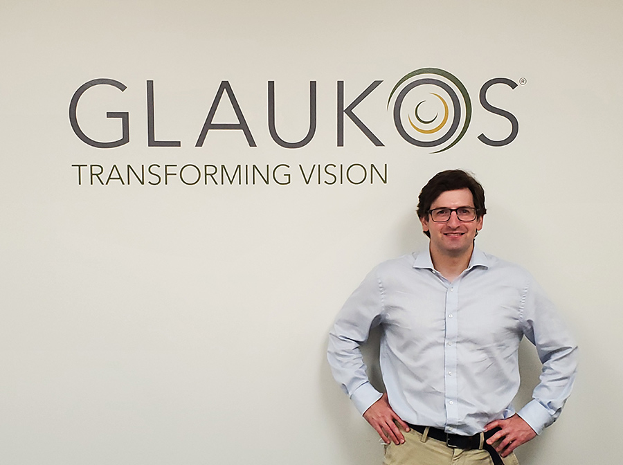 Paul Kyriacopulos standing in front of Glaukos signage, smiling