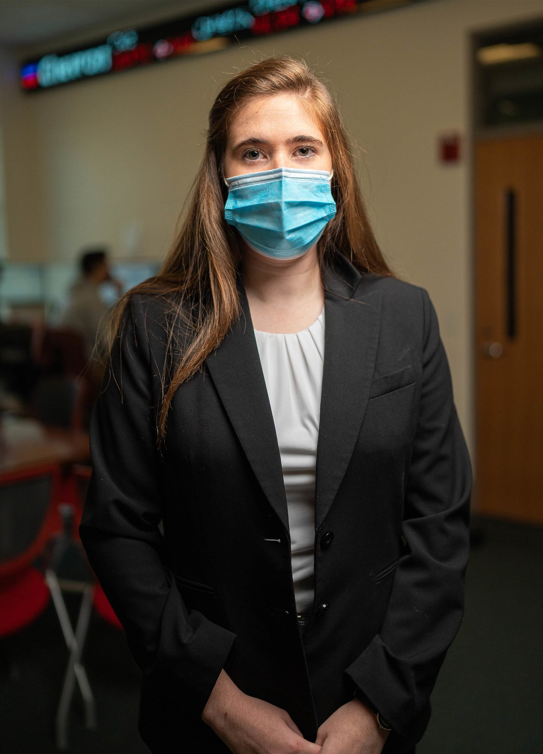 Sarah Blampied ’22 in face mask and dark grey suit jacket