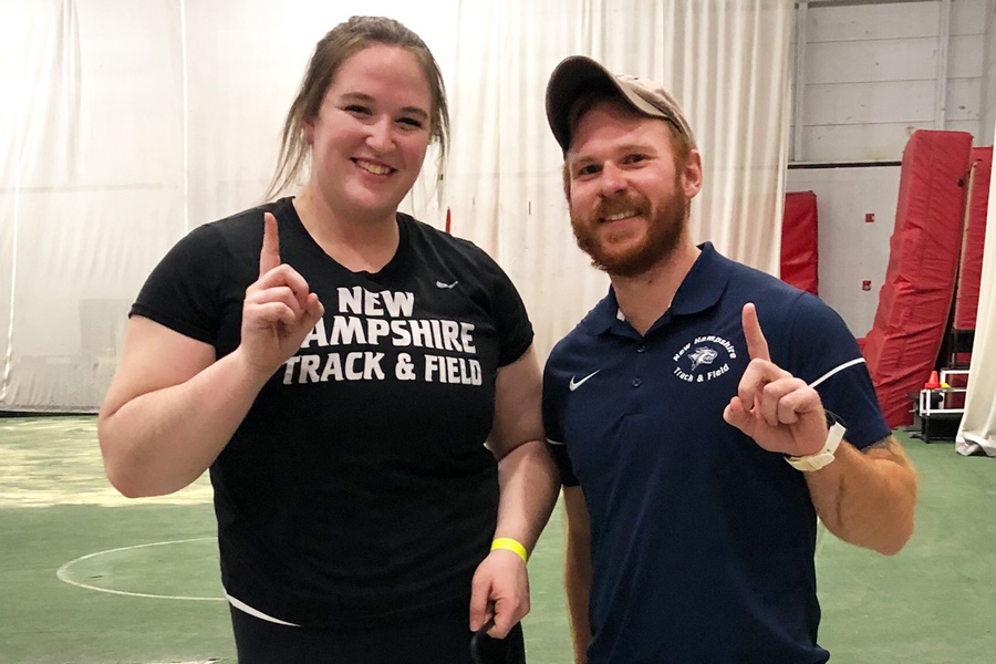 Sarah Williams and her coach holding up their index fingers indicating first place