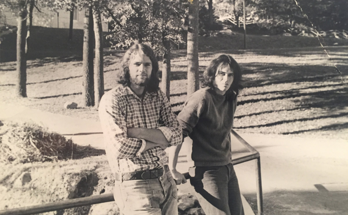 a black and white photo of Billy Welch ’74 (left) and Patrick Varley ’74 (right) standing outside their dorm room