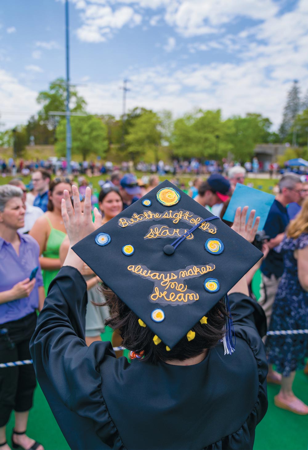 Graduate cap decorated looking at crowd