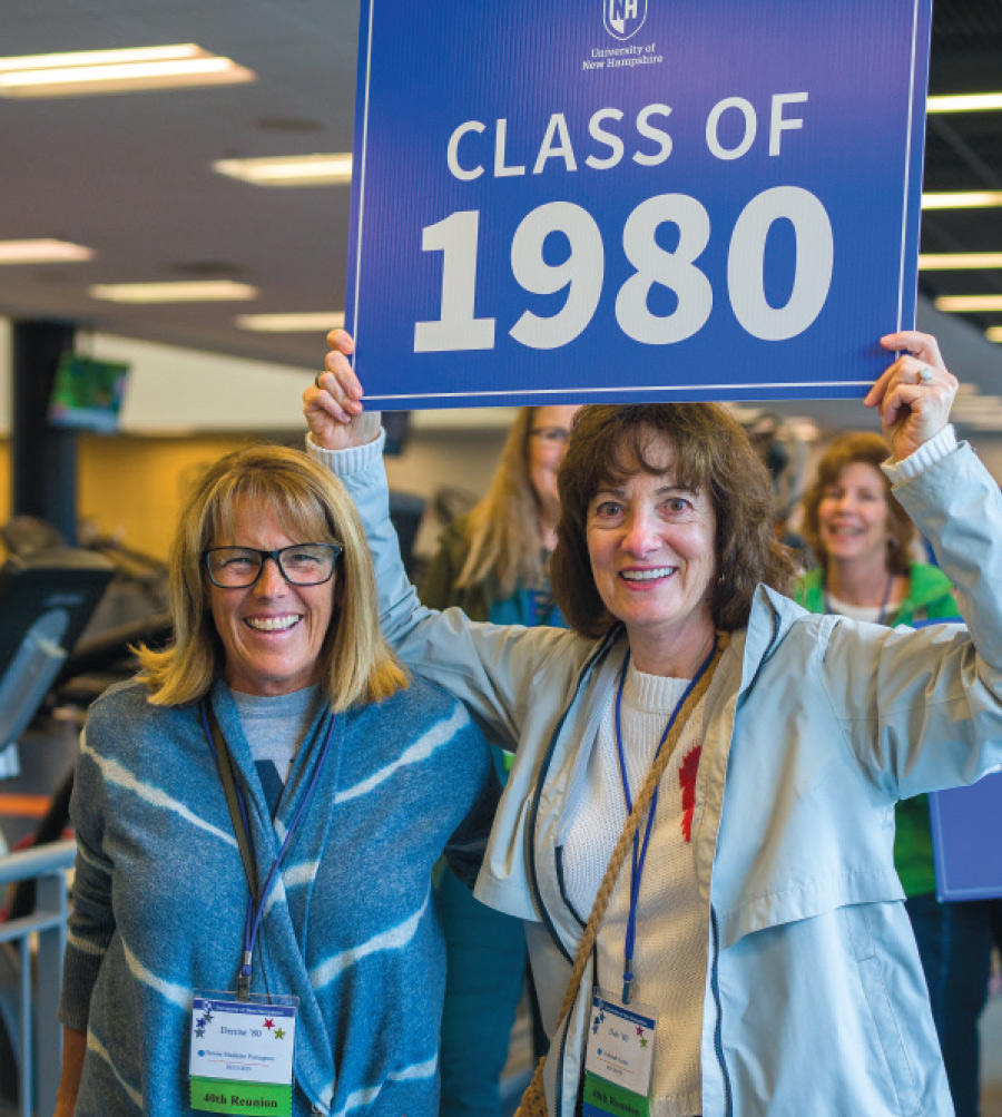 women holding class 1980 sign