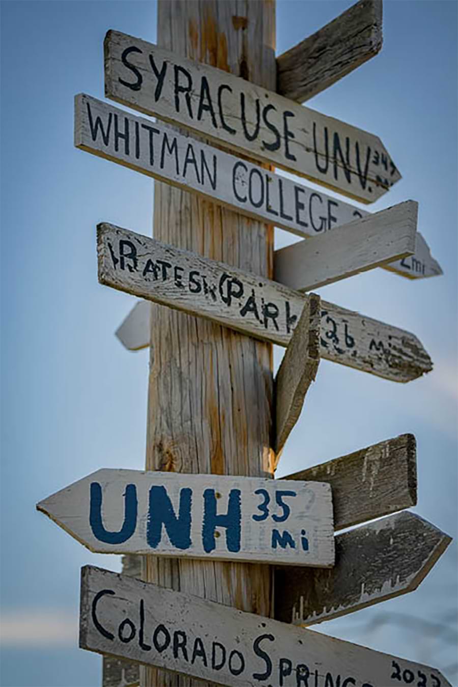Signage at Apple Hill Orchard in Concord includes UNH in its list of destinations.