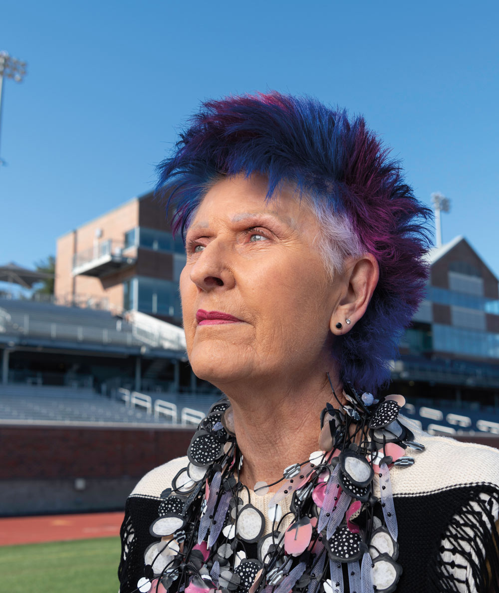 headshot of Dot Sheehan with dyed blue and purple hair