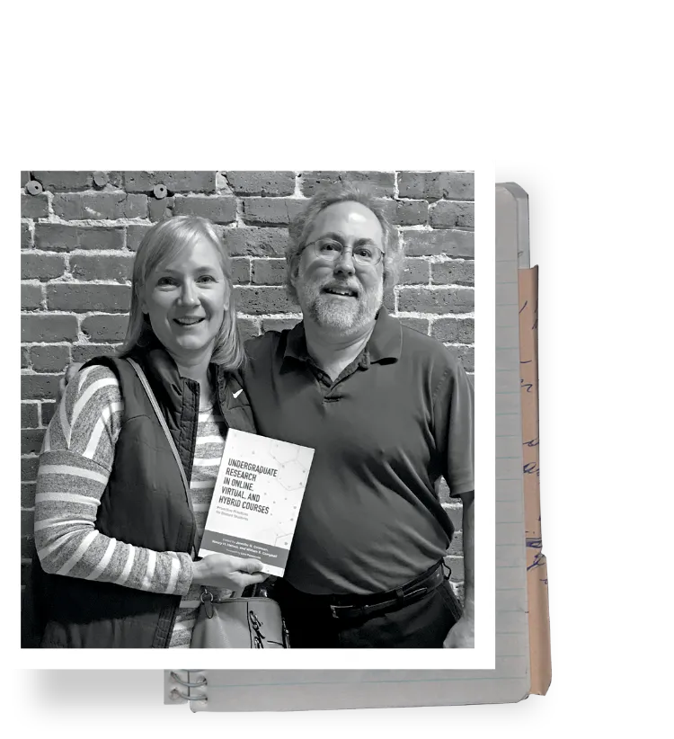 Dr. John Sparrow with Jenny (Hallerman) Coleman holding up book