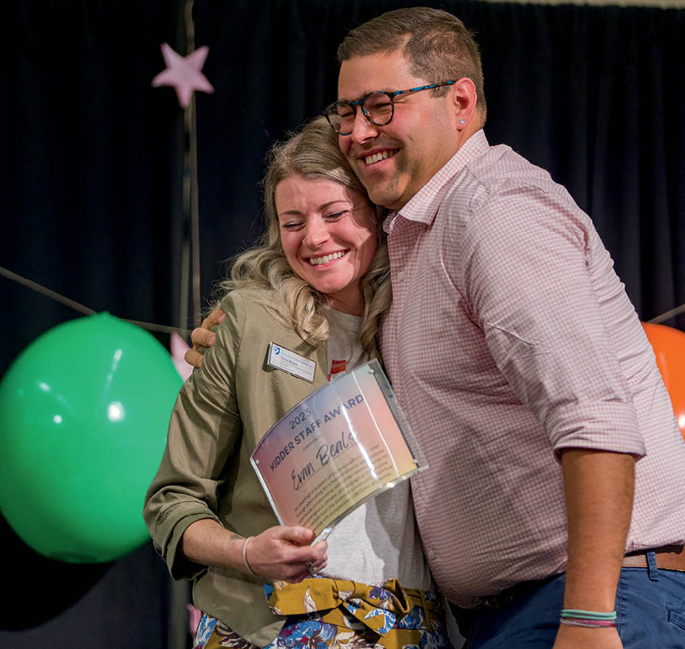 two people posing together with a certificate