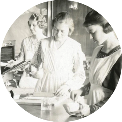 women standing at a table in a cooking lab