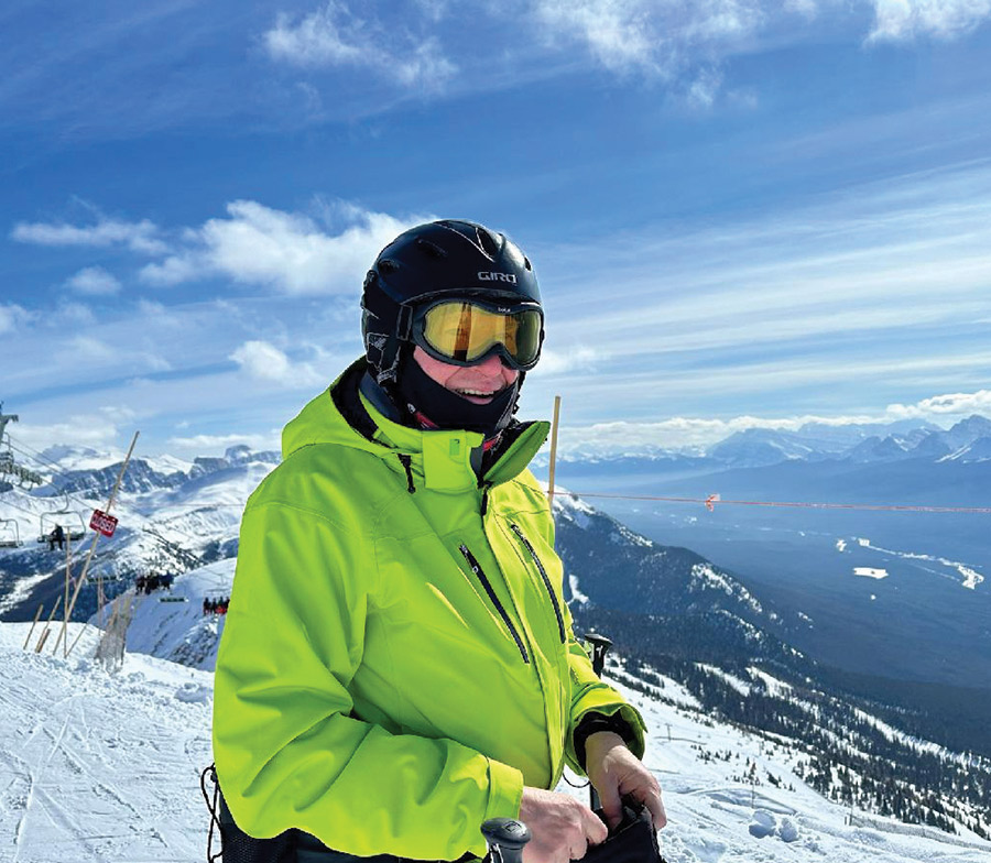 Portrait close-up photograph of Chris Bassett ’75 in snow wear attire atop Whitehorn Mountain at Lake Louise Ski Resort near Banff, Alberta