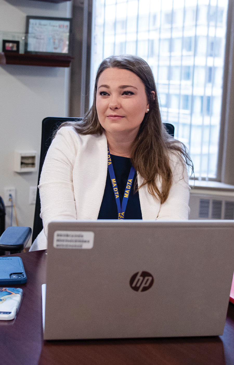 Alana Davidson sitting at her desk in front of her laptop