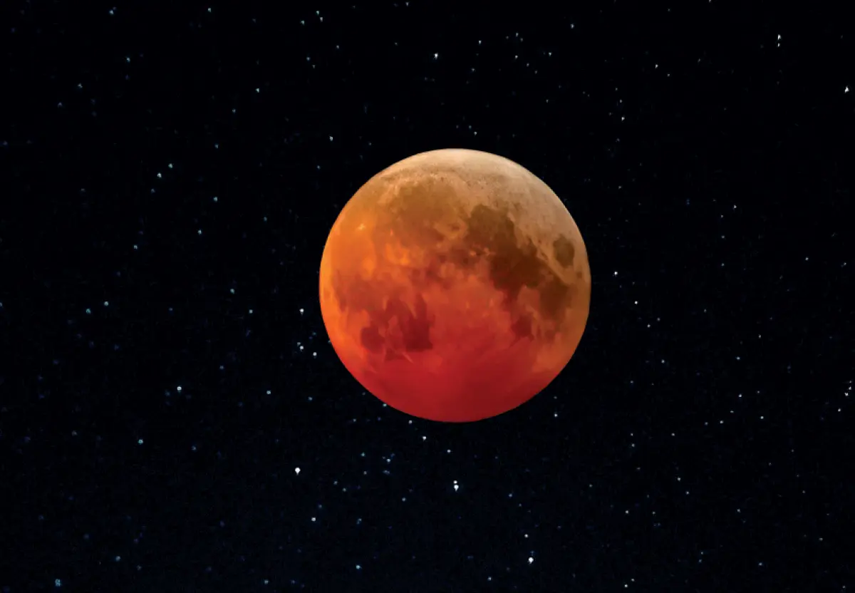 Detailed photo of a reddish-orange moon during a lunar eclipse, set against a dark starry sky; The moon shows visible craters and surface texture; Stephen Crane ’76 photographed the lunar eclipse that occurred on March 14, 2025; Photo was taken at 2:38 am