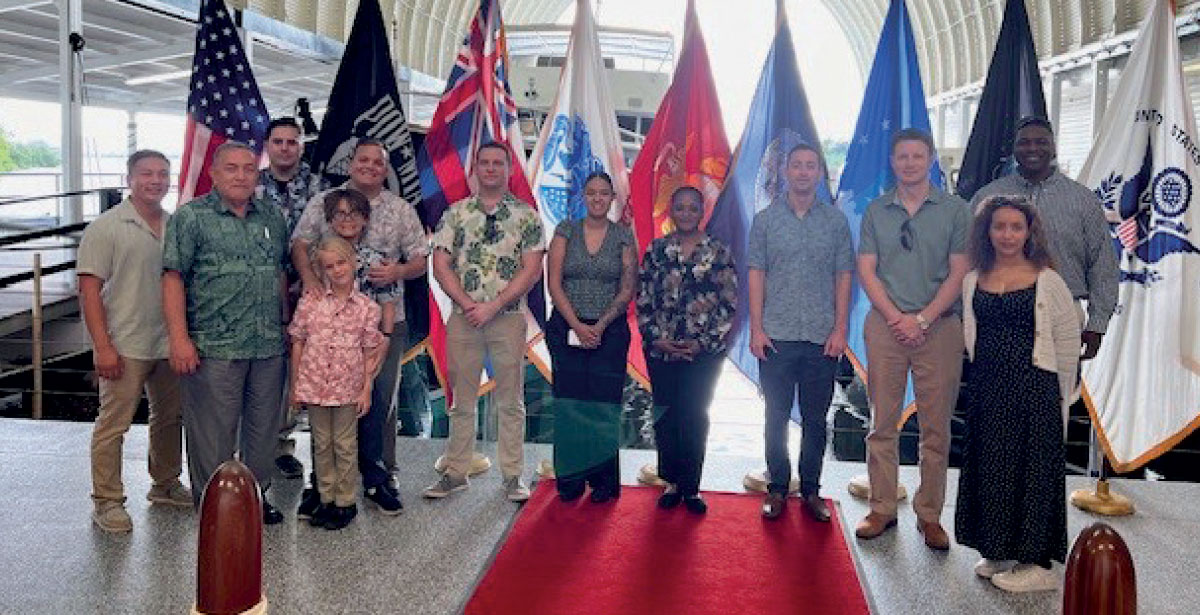Bickford ’80 (second from left) at Pearl Harbor at Admiral’s Pier, May 2024