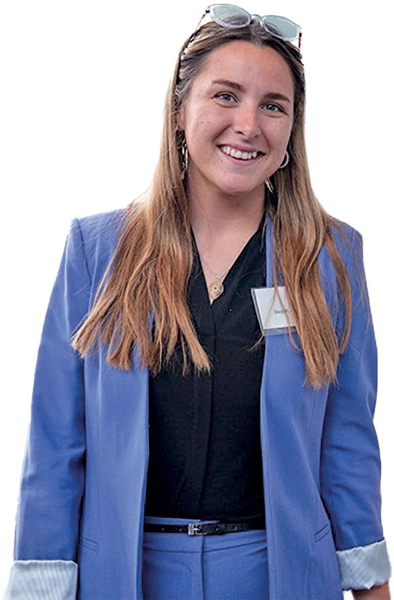 A head-on portrait shot of Autumn Bedell wearing a royal blue pantsuit. 
