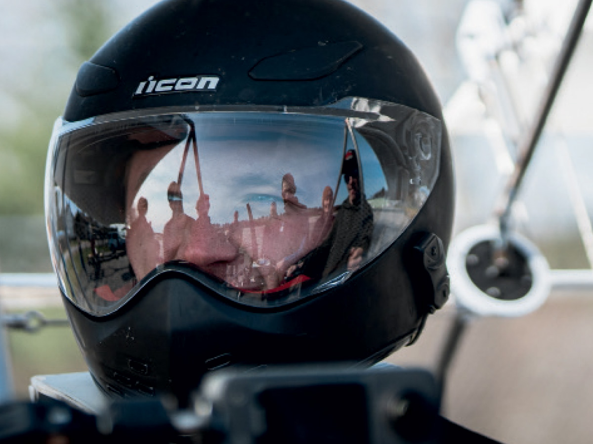 A close-up, eye-level shot of a person wearing a black helmet. 
