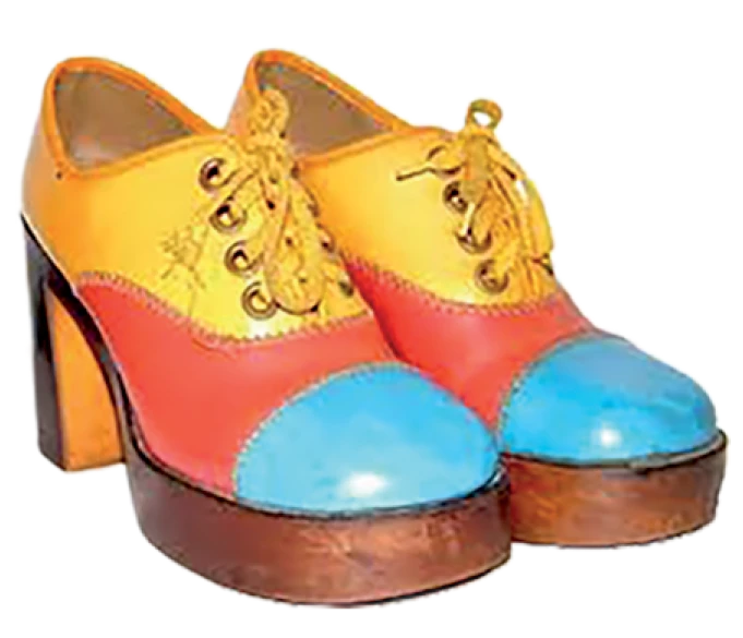 Pair of brightly colored platform shoes in yellow, red, and blue with thick wooden heels.