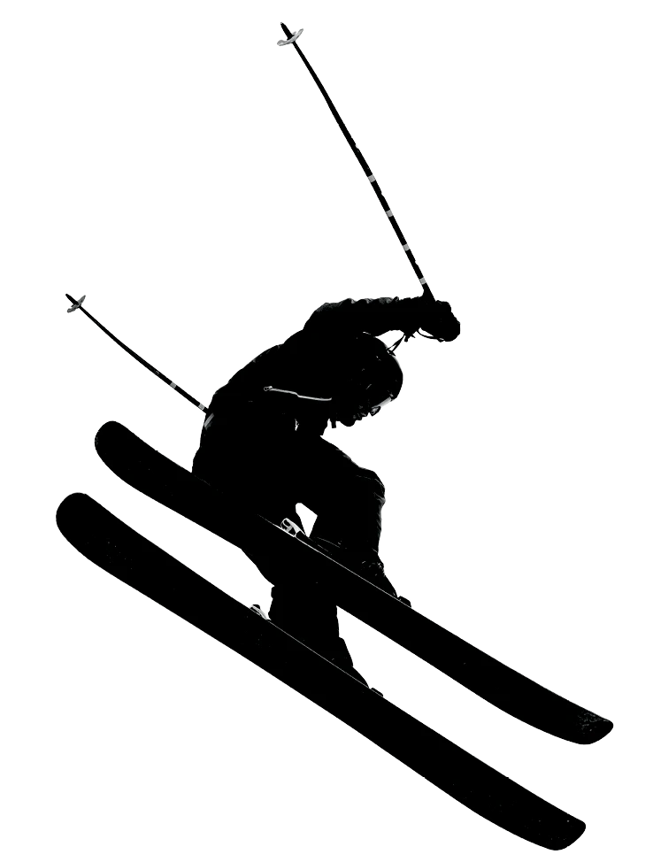 Black silhouette of a skier midair performing a jump with ski poles extended.