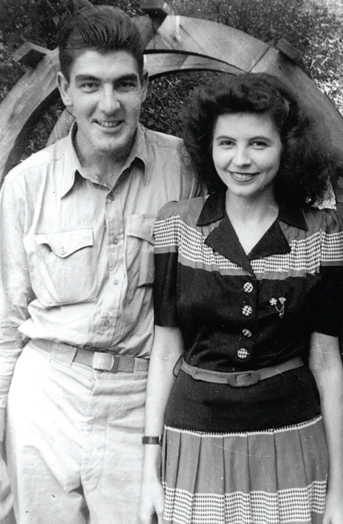 A historical black-and-white portrait of a young man in military-style attire and a woman in a 1940s-style dress in which these people presumably happen to be the parents of Mary (Marceau) Mulvihill