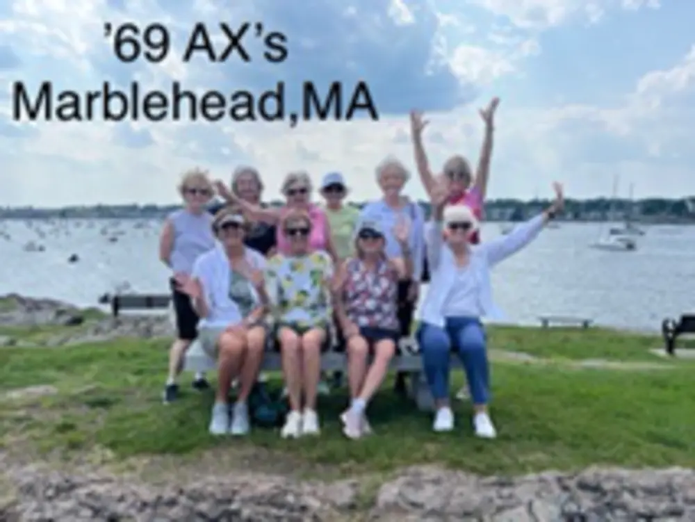 Members of the Class of 1969 Alpha Chi group pose together beside the harbor in Marblehead, Massachusetts.