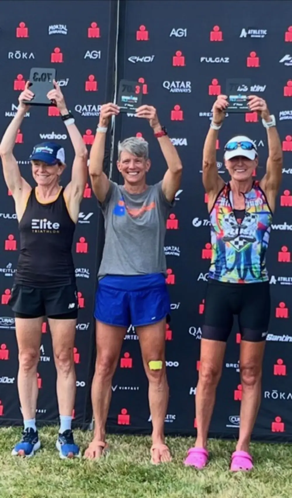 Lisa Gagne Ransom Martin ’84 stands between two other athletes on the winners’ podium at Ironman Maine 70.3.