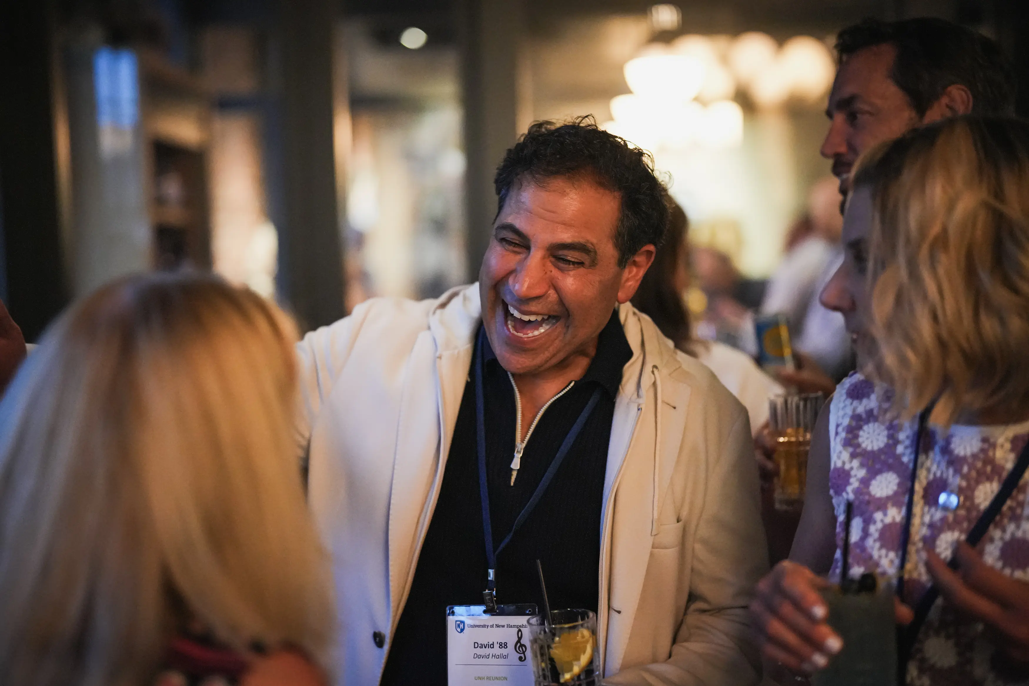 David Hallal ’88 laughs with fellow alumni during an indoor reunion gathering.